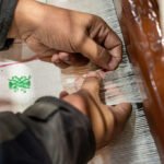 An Indian handloom weaver from Nadia District showcases