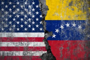 American and Venezuelan flags painted on a cracked concrete wall showing the deep divide and separation between USA and Venezuela
