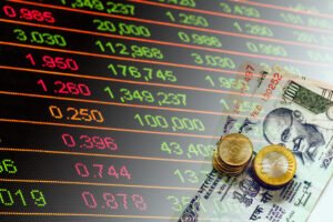Indian Rupees cash banknotes and coins and stock market indicators