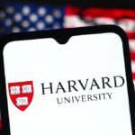 In this photo illustration, the Harvard University logo is