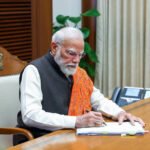 Prime Minister Narendra Modi signs files that are connected with the empowerment of the farmers, Yuva Shakti, and Nari Shakti
