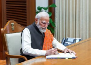 Prime Minister Narendra Modi signs files that are connected with the empowerment of the farmers, Yuva Shakti, and Nari Shakti