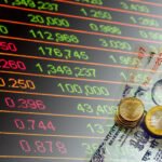 Indian Rupees cash banknotes and coins and stock market indicators