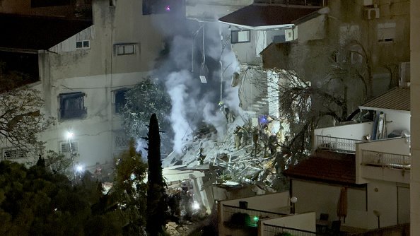 Four people were injured when an Iranian missile directly hit a building in Haifa